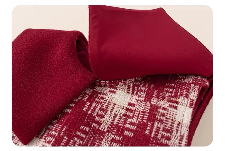 Detail of the Delphine Dress collar, lifted to show its smooth underside above the burgundy and cream tweed.