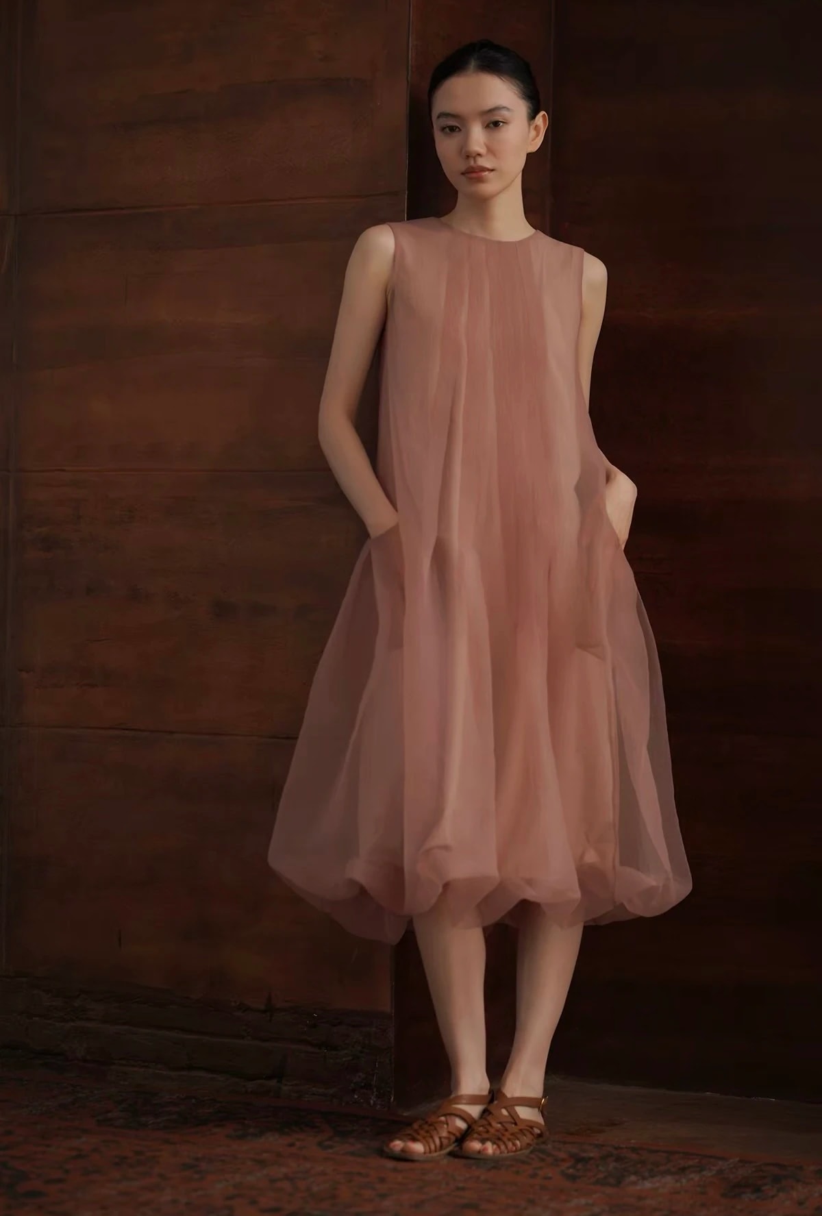 Full-length view of the dusty pink Solene Dress, midi length with its puffed hem.