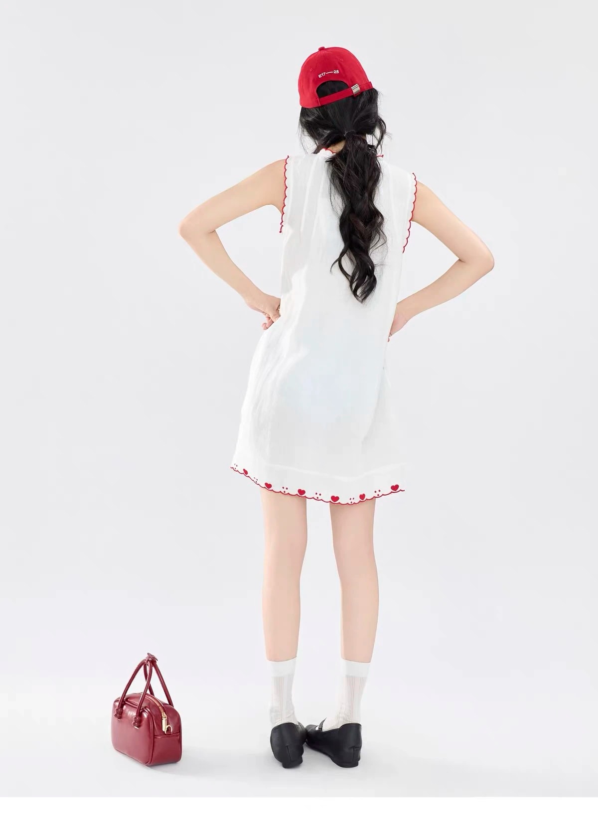 Back view of the Lucie Dress showing the red heart embroidery along the hem.