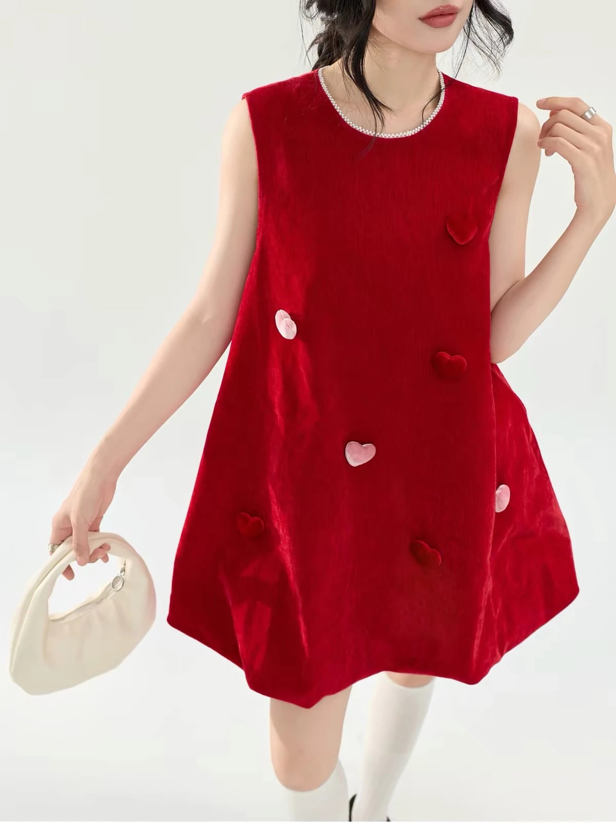 Close front view of the Cerise Dress, showing the pearl-trimmed neckline and the velvet hearts up close.