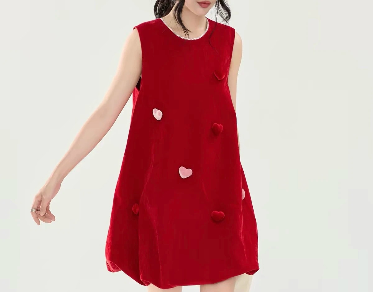 Front view of the Cerise Dress on a woman, showing the pearl-trimmed round neck and the rounded hem.