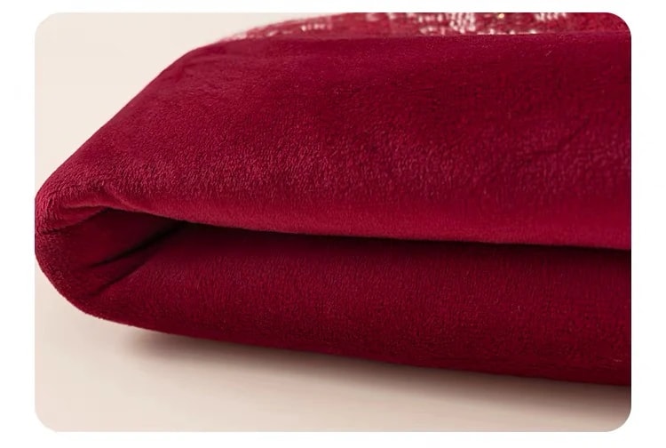 Close-up of the soft burgundy lining of the Delphine Dress, folded at the edge.