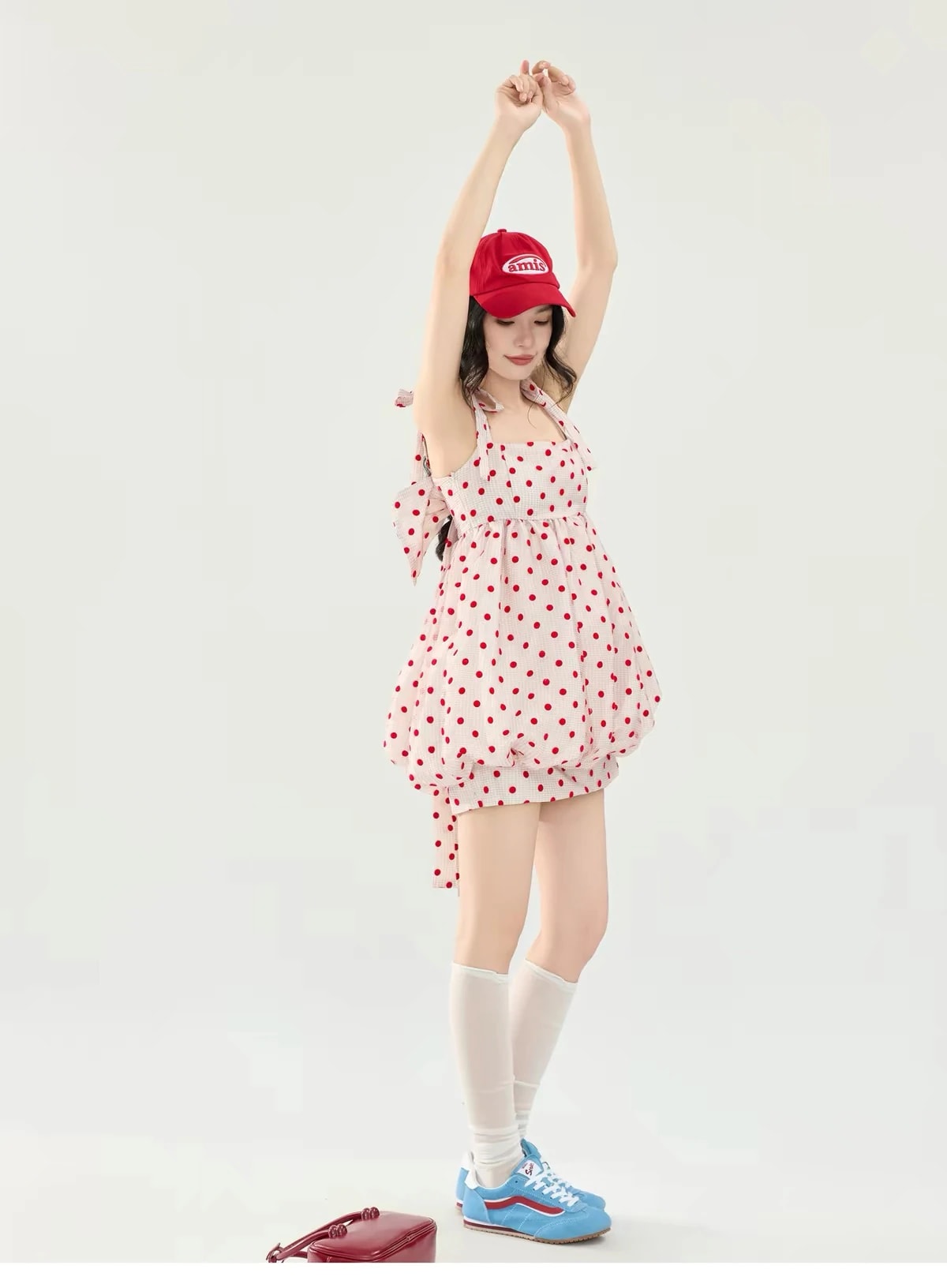 Arms raised in the Josette Dress, showing the gathered high waist and puffy hem.
